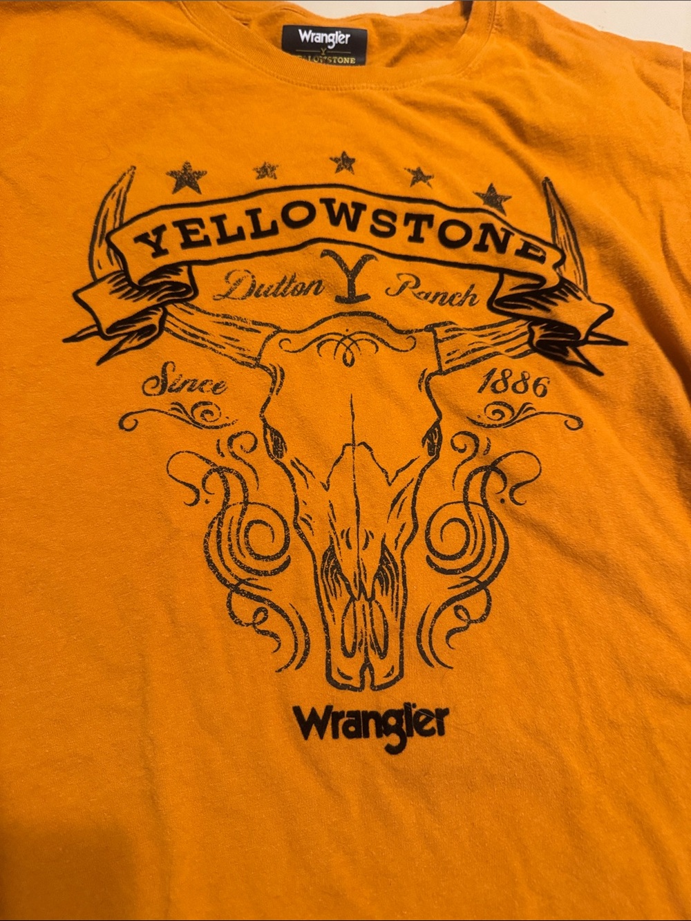 Wrangler Orange Tee with Black Yellowstone Skull Graphic